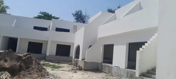 White villa apartments around a sunken courtyard in Paje